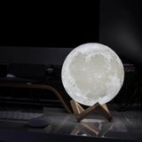 Moon lamp on a stand in a dark room 