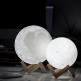 Two moon-shaped lamps on stands with a dark background