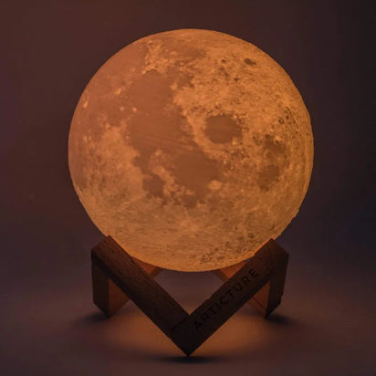 Moon-shaped lamp on a stand with a dark background